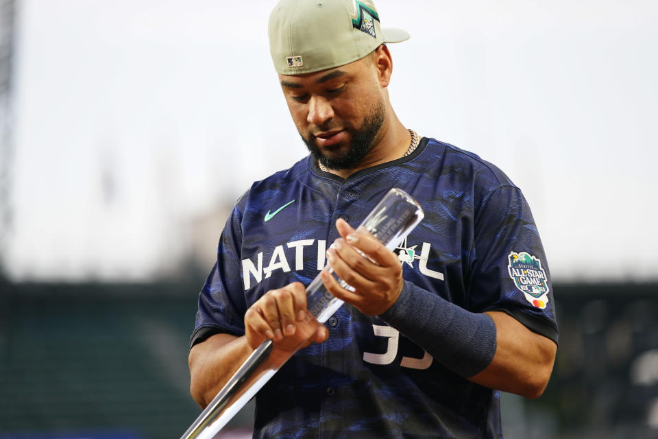 National League's Elias Díaz, of the Colorado Rockies, holds his MVP trophy after the National League defeated the American League 3-2 in the MLB All-Star baseball game in Seattle, Tuesday, July 11, 2023. (AP Photo/Lindsey Wasson)
