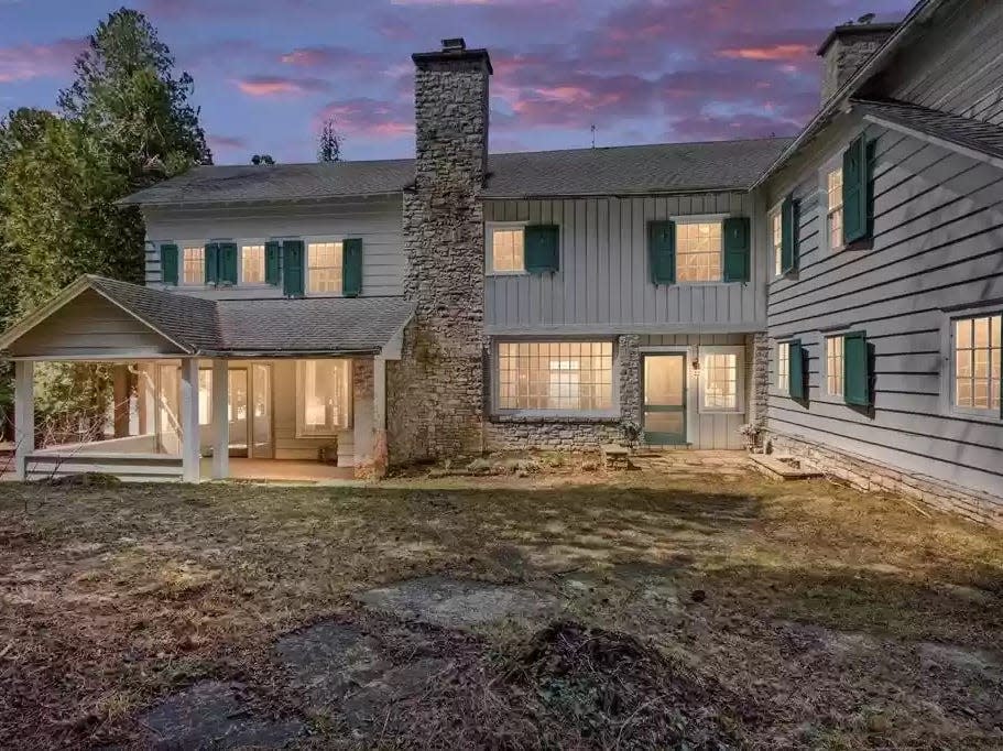 two story house with shutters and a chimney shown at sunset in Wisconsin