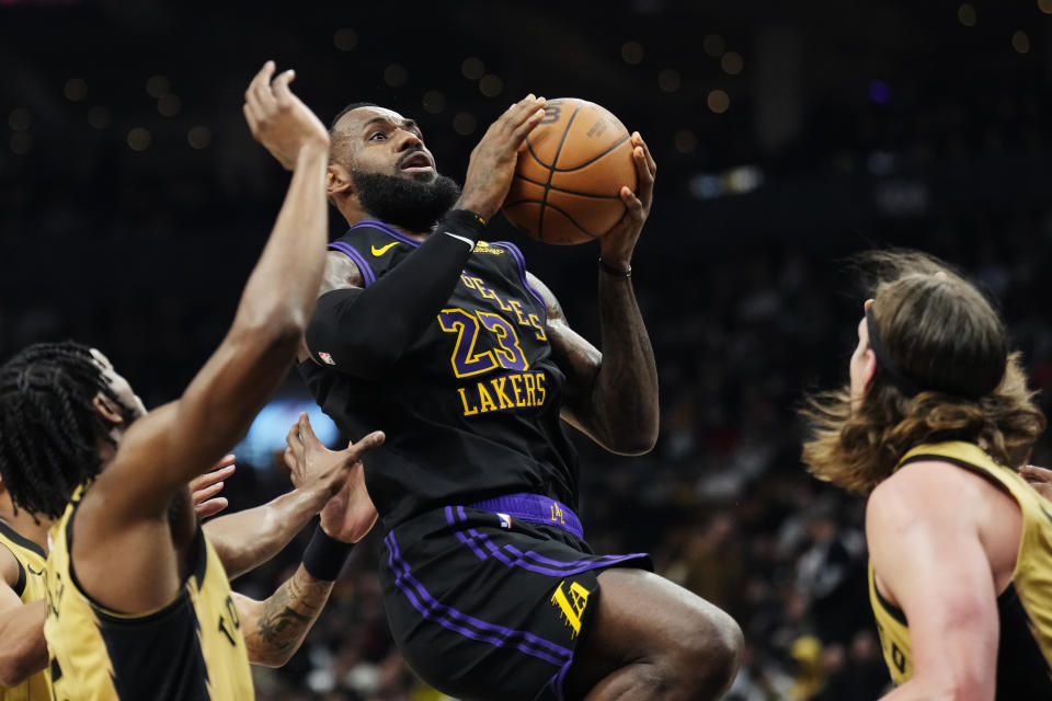 Los Angeles Lakers forward LeBron James (23) shoots against the Toronto Raptors during the second half of an NBA basketball game Tuesday, April 2, 2024, in Toronto. (Frank Gunn/The Canadian Press via AP)