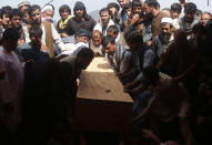 Afghans carry the body of a victim of the Dubai City wedding hall bombing during a mass funeral in Kabul, Afghanistan, Sunday, Aug.18, 2019. The deadly bombing at the wedding in Afghanistan's capital late Saturday that killed dozens of people was a stark reminder that the war-weary country faces daily threats not only from the long-established Taliban but also from a brutal local affiliate of the Islamic State group, which claimed responsibility for the attack. (AP Photo/Rafiq Maqbool)