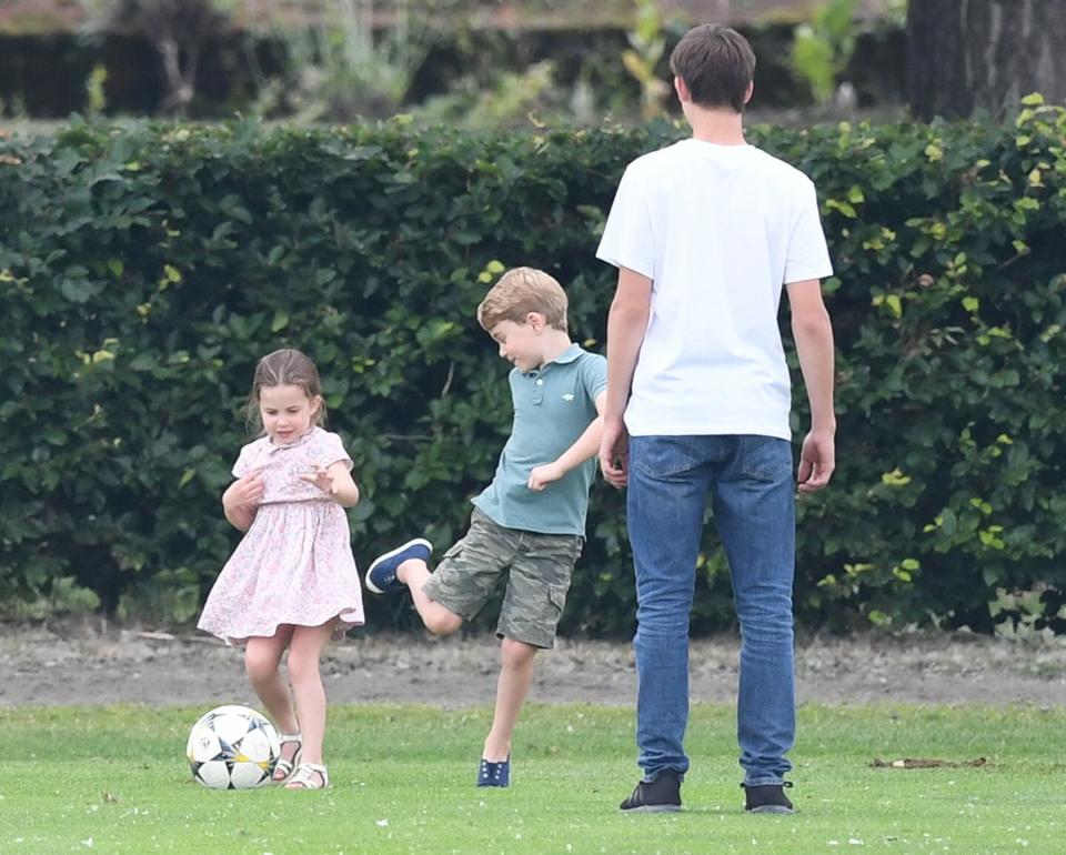 Princess Charlotte and Prince George's attention was more focused on kicking around a soccer ball than watching dad's game.