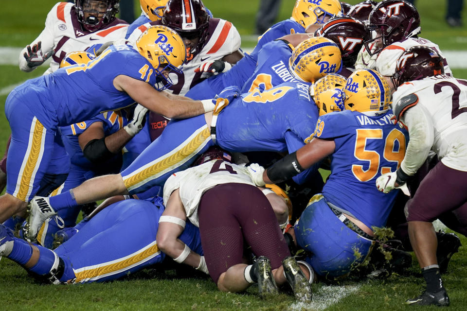 Pittsburgh quarterback Kenny Pickett (8) sneaks through the pile to score a touchdown against Virginia Tech during the second half of an NCAA college football game, Saturday, Nov. 21, 2020, in Pittsburgh. (AP Photo/Keith Srakocic)