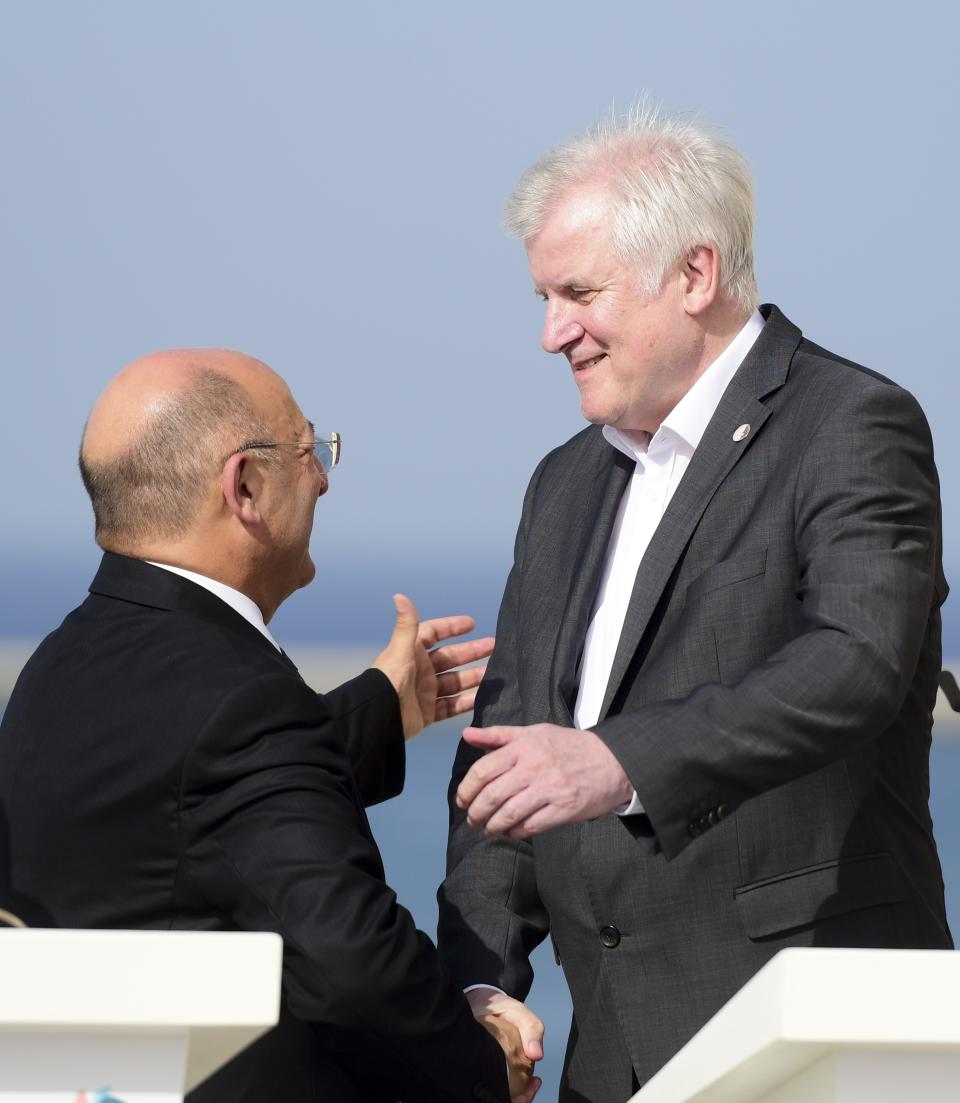 German Interior Minister Horst Seehofer, right, shakes hands with Maltese Interior Minister Michael Farrugia at the end of a joint press conference at the end of an informal meeting of EU interior ministers, at Fort St. Angelo, in Birgu, Malta, Monday, Sept. 23, 2019. Five European Union nations have agreed to a temporary arrangement to take in migrants rescued from the central Mediterranean Sea. (AP Photo/Jonathan Borg)