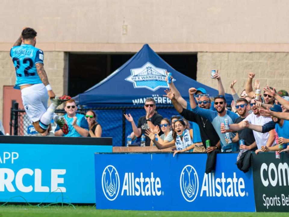 Halifax Wanderers fans celebrate a goal in a 1-0 victory over FC Edmonton during the 2021 season of the Canadian Premier League at the Wanderers Grounds in Halifax. (Trevor MacMillan/HFX Wanderers FC - image credit)