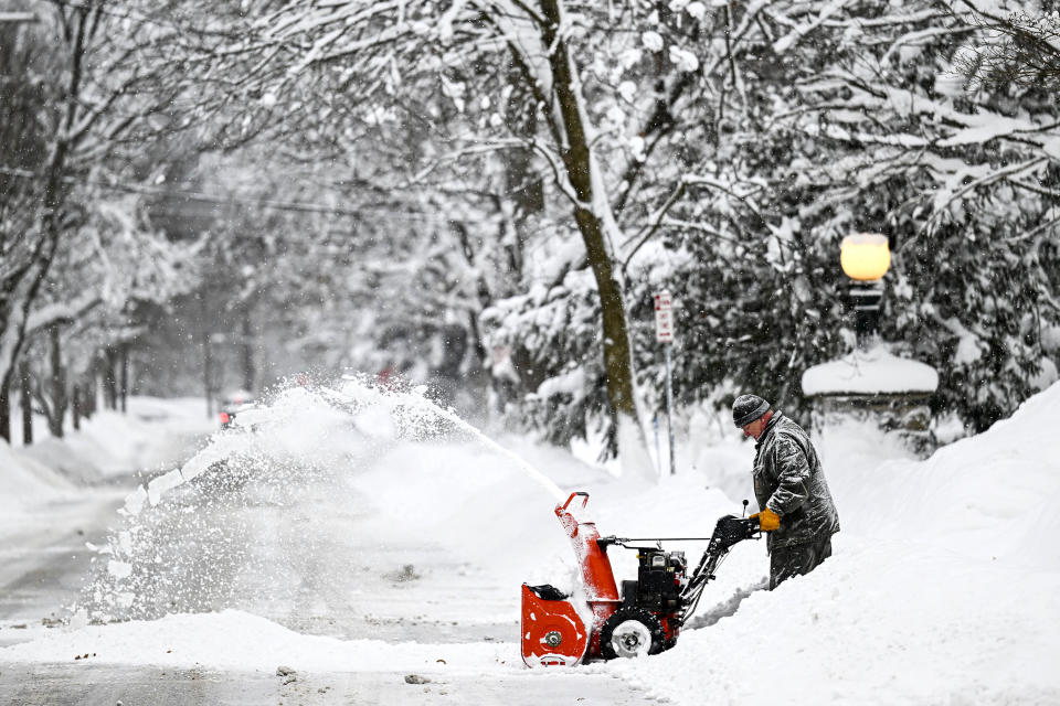 A man shovels snow after snowfall as death toll in the snowstorm, which was effective, reached 26 in Buffalo, New York, United States on December 26, 2022. (Fatih Aktas / Anadolu Agency via Getty Images)