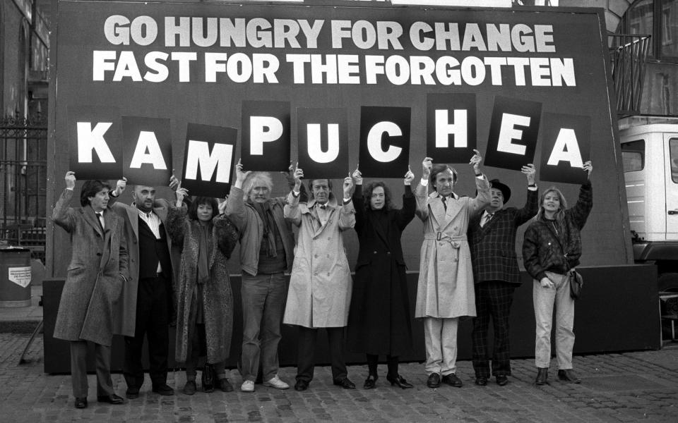 1988: Pilger forms a human billboard with celebrities to share a message about Kampuchea (commonly known as the Khmer Rouge)