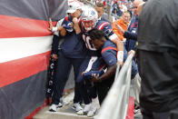 New England Patriots quarterback Mac Jones (10) is helped off the field after suffering a leg injury with less than two minutes to play in the second half of an NFL football game against the Baltimore Ravens, Sunday, Sept. 25, 2022, in Foxborough, Mass. (AP Photo/Michael Dwyer)