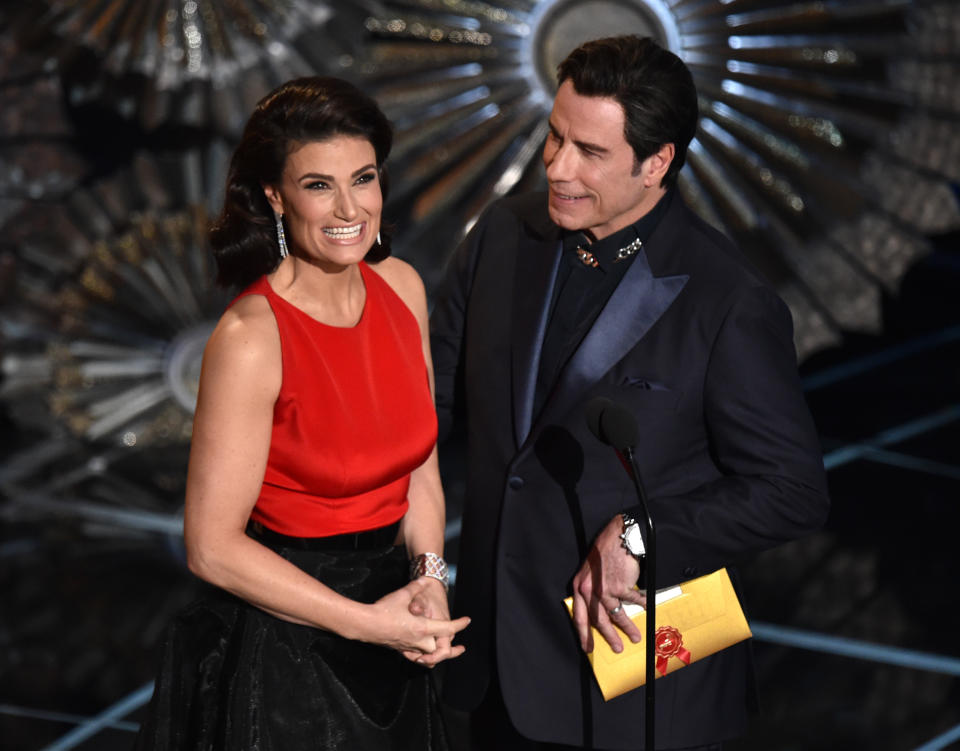 Idina Menzel, left and John Travolta present the award for best original song at the Oscars on Sunday, Feb. 22, 2015, at the Dolby Theatre in Los Angeles. (Photo by John Shearer/Invision/AP)