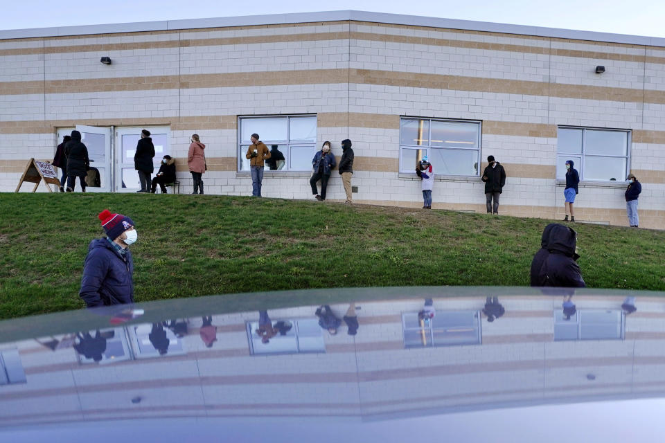 Voters wait to cast their ballots in the general election outside the East End Elementary School, Tuesday, Nov. 3, 2020, in Portland, Maine.(AP Photo/Robert F. Bukaty)