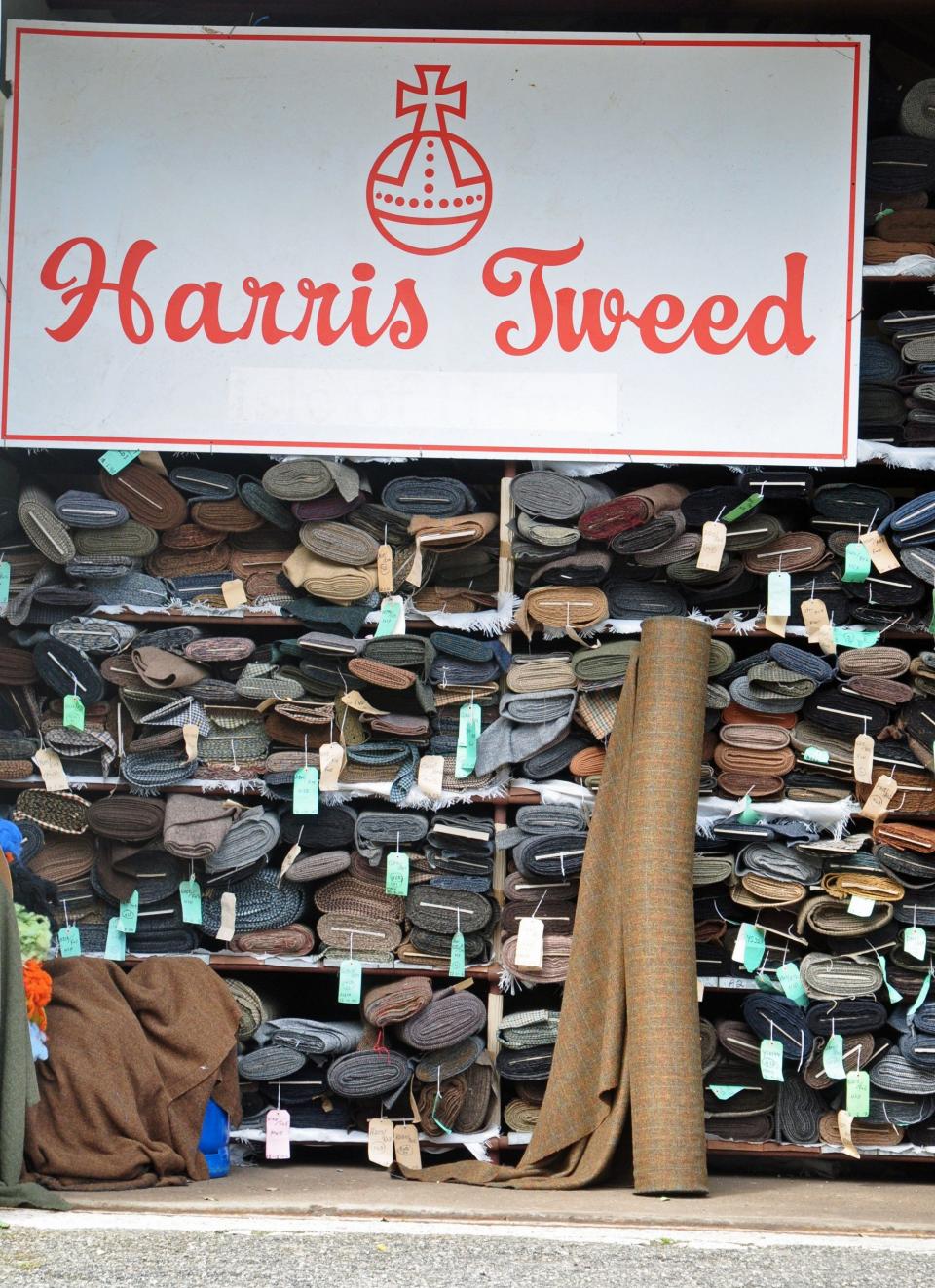 Rolls of Harris Tweed cloth in a warehouse - Alun John/Alamy