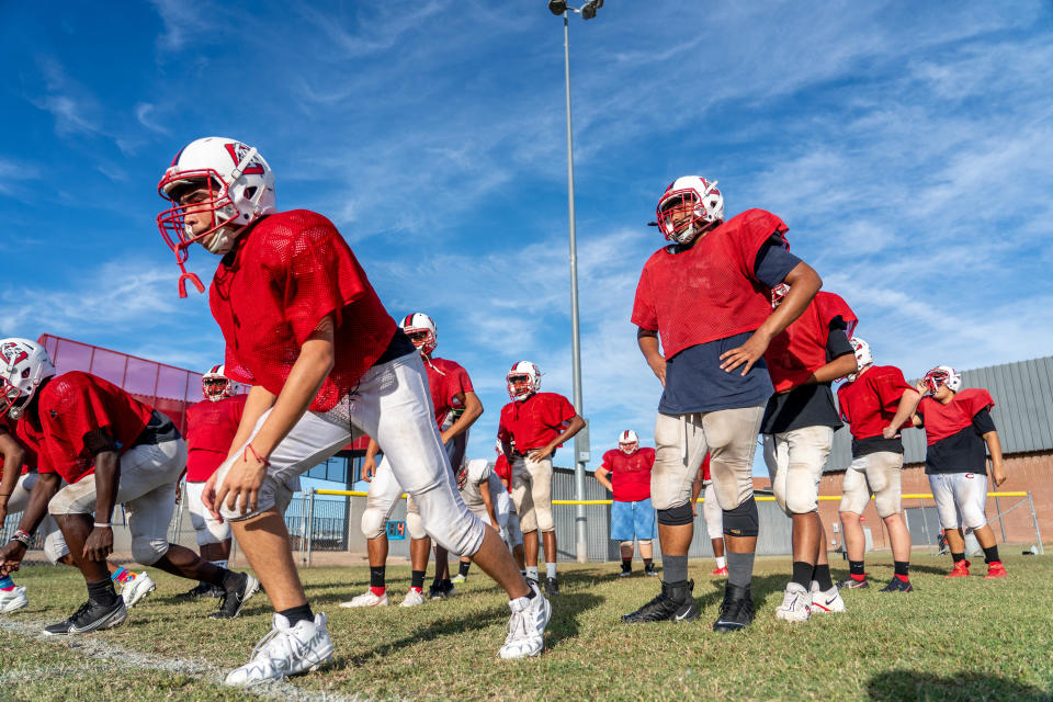 Cesar Haro Ruiz (left), a junior playing safety and wide receiver in Cortez High School's football program, and Andres Varela (right), a junior playing offensive guard and defensive tackle, attend a practice on campus in Phoenix on Oct. 19, 2022.