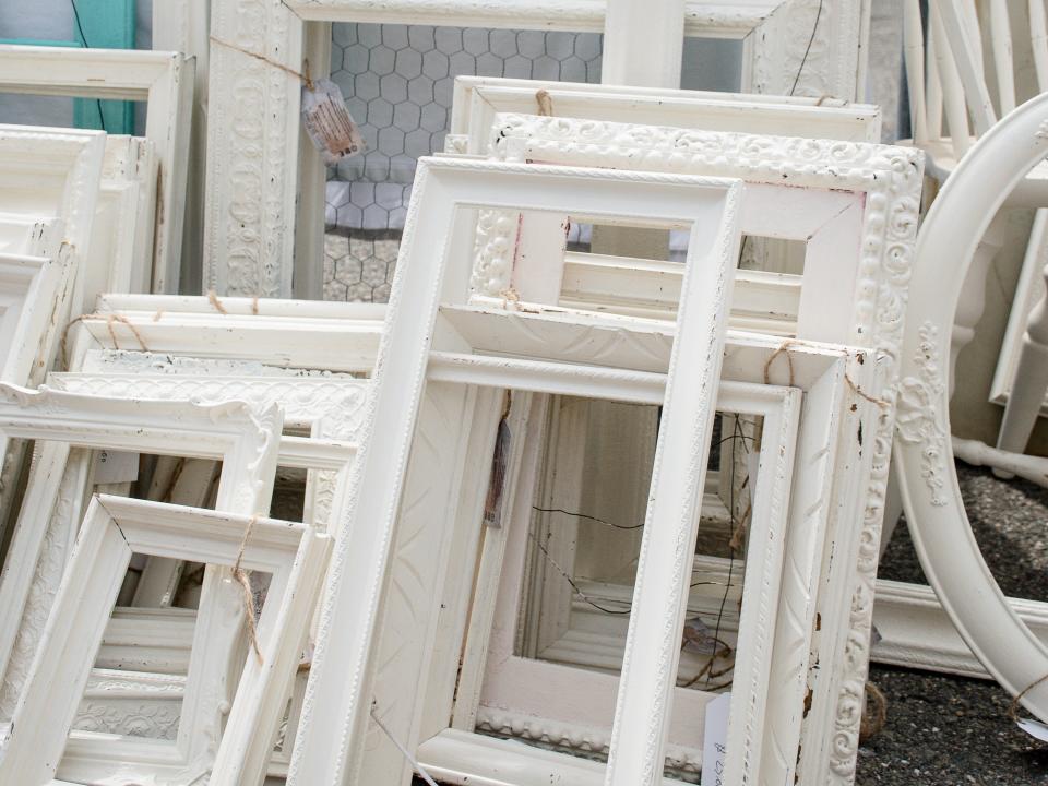 Wooden picture frames painted white stacked vertically