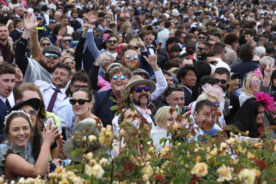 People crowd onto the rail before the start of the Melbourne Cup horse race in Melbourne, Australia, Tuesday, Nov. 1, 2022. (AP Photo/Asanka Brendon Ratnayake)