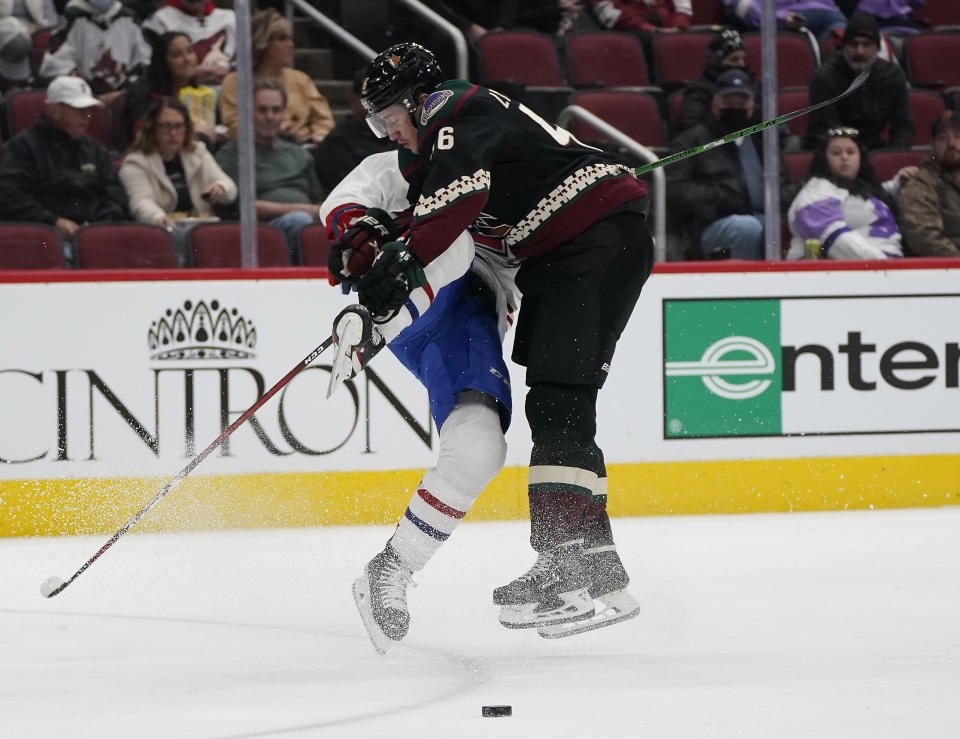 Arizona Coyotes' Ilya Lyubushkin (46) bodychecks Montreal Canadiens' Laurent Dauphin, left, during the second period of an NHL hockey game Monday, Jan. 17, 2022, in Glendale, Ariz. (AP Photo/Darryl Webb)