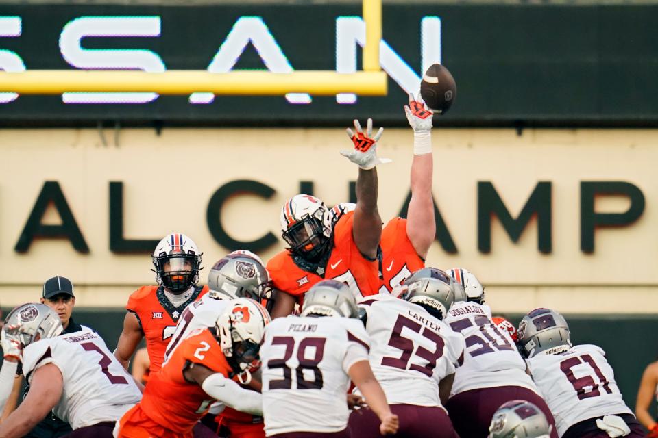 Missouri State kicker Jose Pizano (38) kicks a field goal over the Oklahoma State defense in the first half of an NCAA college football game, Saturday, Sept. 4, 2021, in Stillwater, Okla. (AP Photo/Sue Ogrocki)