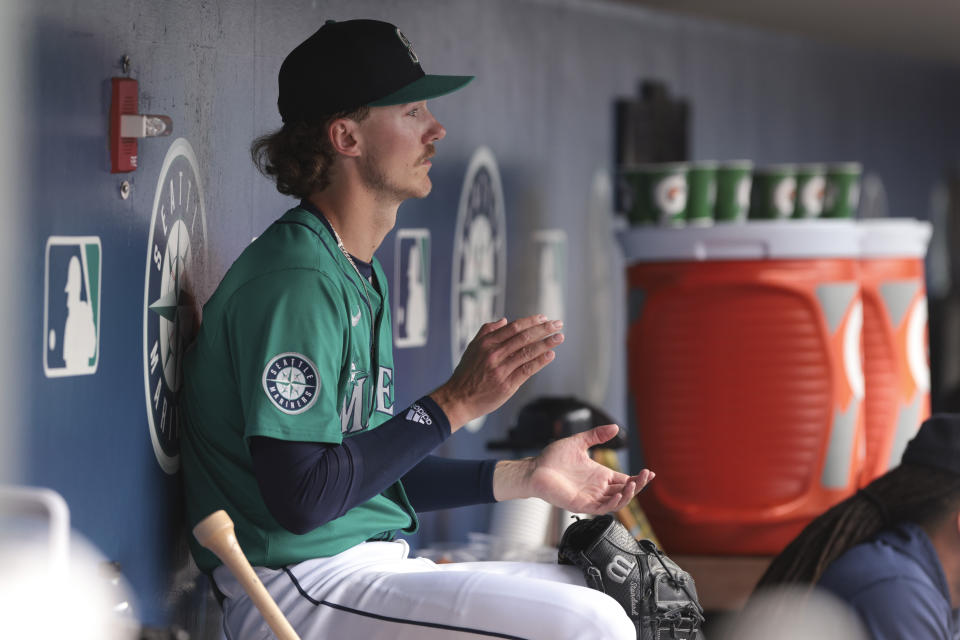 Seattle Mariners starting pitcher Bryce Miller cheers from the dugout during the sixth inning of the team's baseball game against the Los Angeles Angels, Saturday, June 1, 2024, in Seattle. (AP Photo/Jason Redmond)