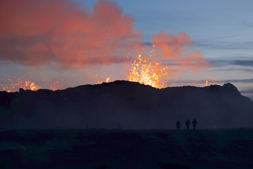 People watch a volcanic eruption at Litli Hrutur, south-west of Reykjavik in Iceland. (AFP/Getty)