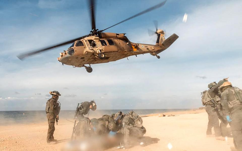 Members of Unit 669 of the Israeli Air Force preparing an Israeli soldier for evacuation