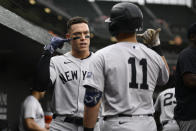 New York Yankees' Aaron Judge, left, and Anthony Volpe (11) react before a baseball game against the Baltimore Orioles, Tuesday, April 30, 2024, in Baltimore. (AP Photo/Nick Wass)