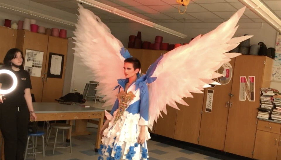 North Bergen High School students CJ King, wearing the Junk Kouture creation, with Jazzlynn Vargas holding the light.