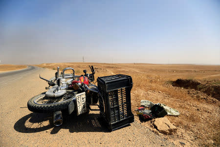 Motorcycle used by Islamic State militants is left on the road during the war between Iraqi army and Shi'ite Popular Mobilization Forces (PMF) against the Islamic State militants in al-Ayadiya, northwest of Tal Afar, Iraq August 28, 2017. REUTERS/Thaier Al-Sudani