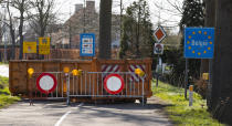 A container and barriers block a backroad used by locals on the Netherlands border with Belgium between Chaam, southern Netherlands, and Meerle, northern Belgium, Monday, March 23, 2020. Both countries have come to a near standstill as their governments sought to prevent the further spread of coronavirus. For most people, the new coronavirus causes only mild or moderate symptoms, such as fever and cough. For some, especially older adults and people with existing health problems, it can cause more severe illness, including pneumonia. (AP Photo/Peter Dejong)