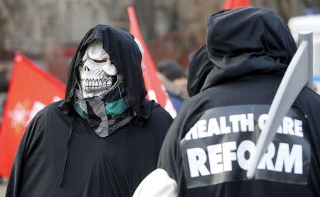 An activist wears a skull mask during a protest in support of Russian doctors and patients against reforms to the healthcare system in Moscow in this November 30, 2014 file photo. REUTERS/Sergei Karpukhin/Files