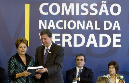 Brazilian President Dilma Rousseff (L) receives the report from Pedro Dallari (2nd L), a member of the "truth commission", in Brasilia December 10, 2014. REUTERS/Joedson Alves