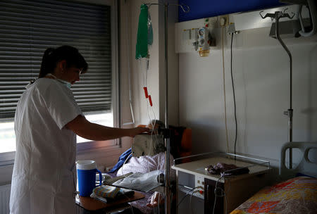 French nurse Anne Besnier treats a patient at the hospital of Laval, France, November 8, 2018. Picture taken November 8, 2018. REUTERS/Stephane Mahe