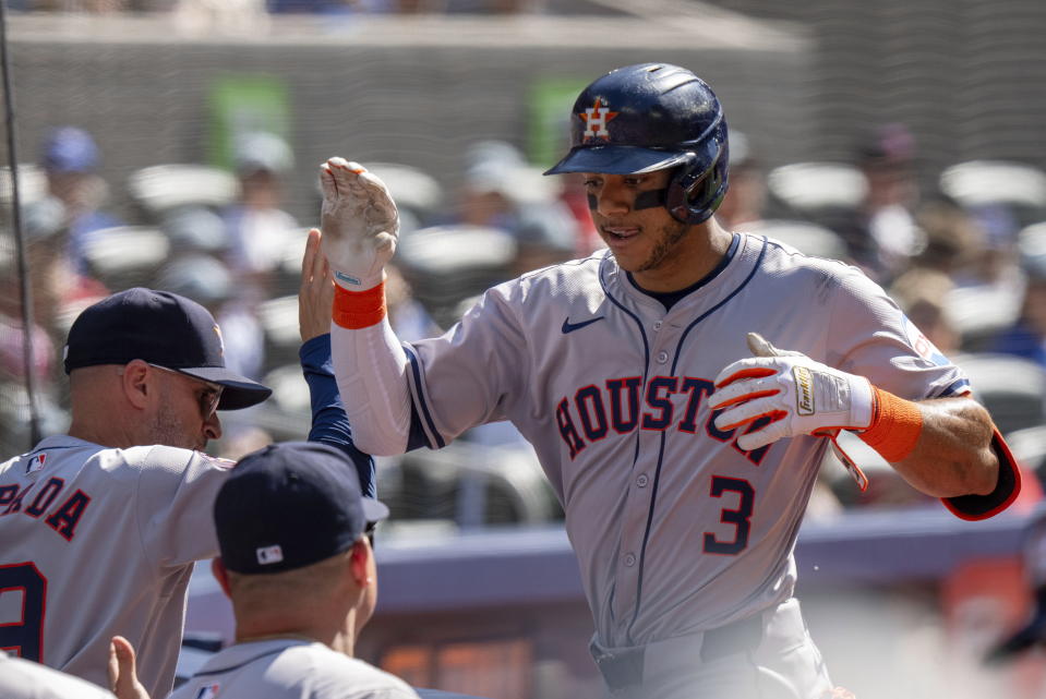 Houston Astros shortstop Jeremy Peña (3) is congratulated by manager Joe Espada, left, after hitting a solo home run against the Toronto Blue Jays in fifth-inning baseball game action in Toronto, Monday, July 1, 2024. (Frank Gunn/The Canadian Press via AP)