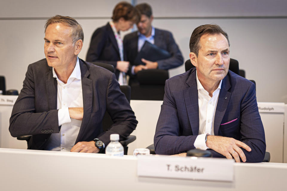 Oliver Blume, left, Chairman of the Board of Management of Volkswagen AG and Porsche AG, and Thomas Sch'fer, Member of the Board of Management of the Volkswagen brand, take part in a work meeting in a hall at the VW plant in Wolfsburg, Wednesday, Sept. 4, 2024. Volkswagen has announced that it will tighten its austerity measures due to the tense situation of the core brand. Redundancies and plant closures can no longer be ruled out. (Moritz Frankenberg/pool photo via AP)