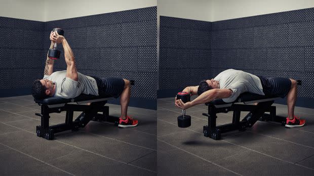 Man performs dumbbell pull-over exercise in a gym