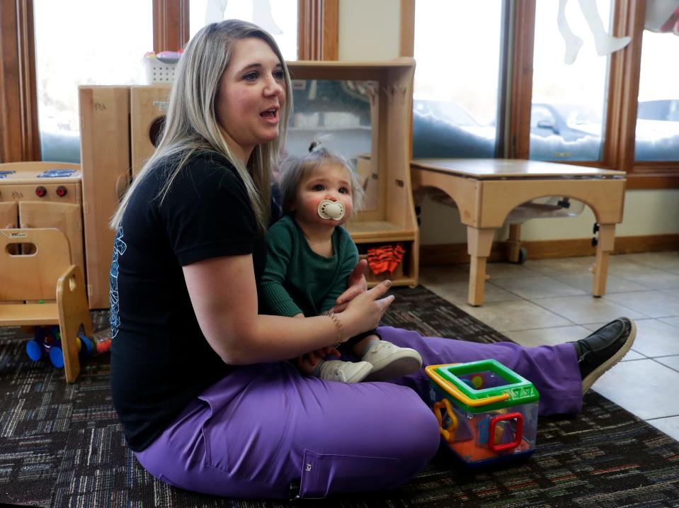 Destiny Desotell sits with her daughter, Madelyn, while talking about finding childcare at Encompass Early Education & Care's Bellin Health Center location on Feb. 24, 2023, in Allouez, Wis.