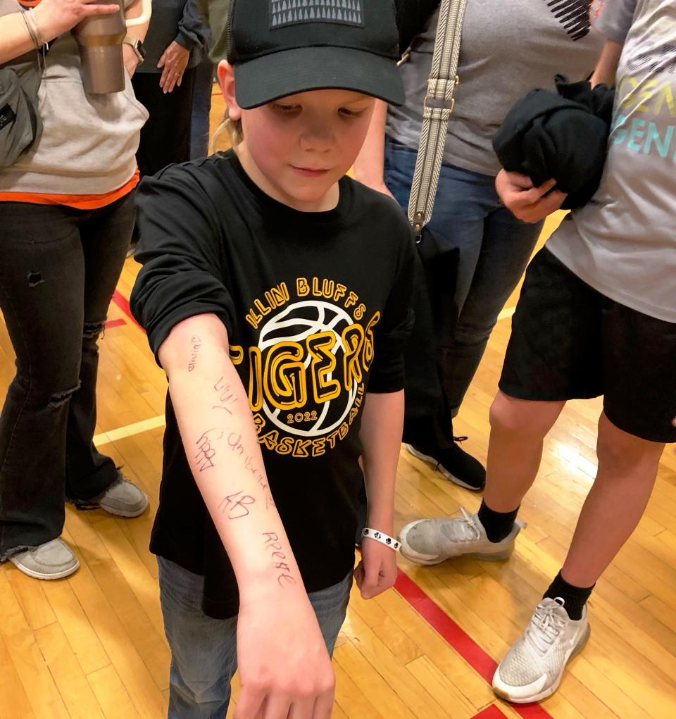 Illini Bluffs fan Sawyer Reimer, 9, collected autographs from every member of the Tigers team after they upset No. 1 Galena, 47-41, in the IHSA Class 1A girls Super-Sectional at Brimfield on Monday, Feb. 26, 2024.