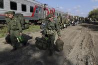 FILE - Russian recruits walk to take a train at a railway station in Prudboi, Volgograd region of Russia, on Sept. 29, 2022. Russian President Vladimir Putin has ordered a partial mobilization of reservists to beef up his forces in Ukraine. (AP Photo, File)