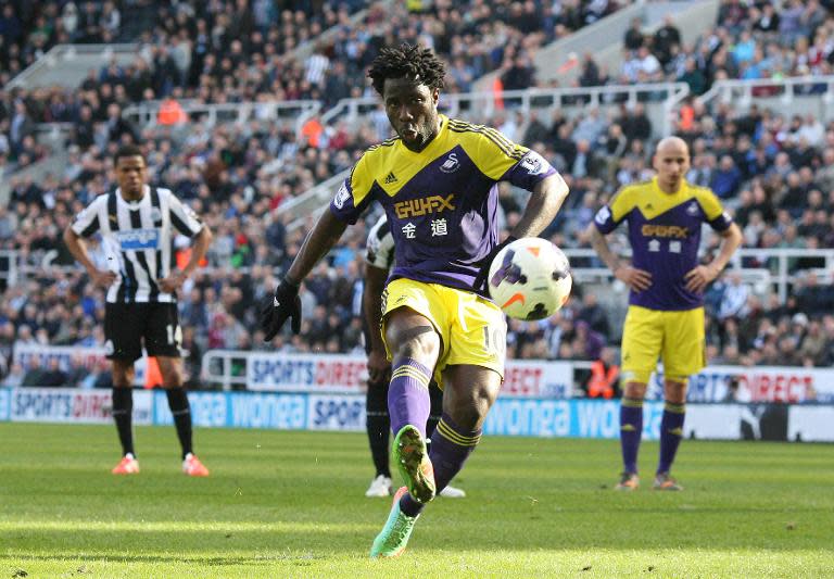 Swansea's striker Wilfried Bony scores their second goal from a penalty during an English Premier League football match against Newcastle United at St James' Park in Newcastle, northeast England on April 19, 2014