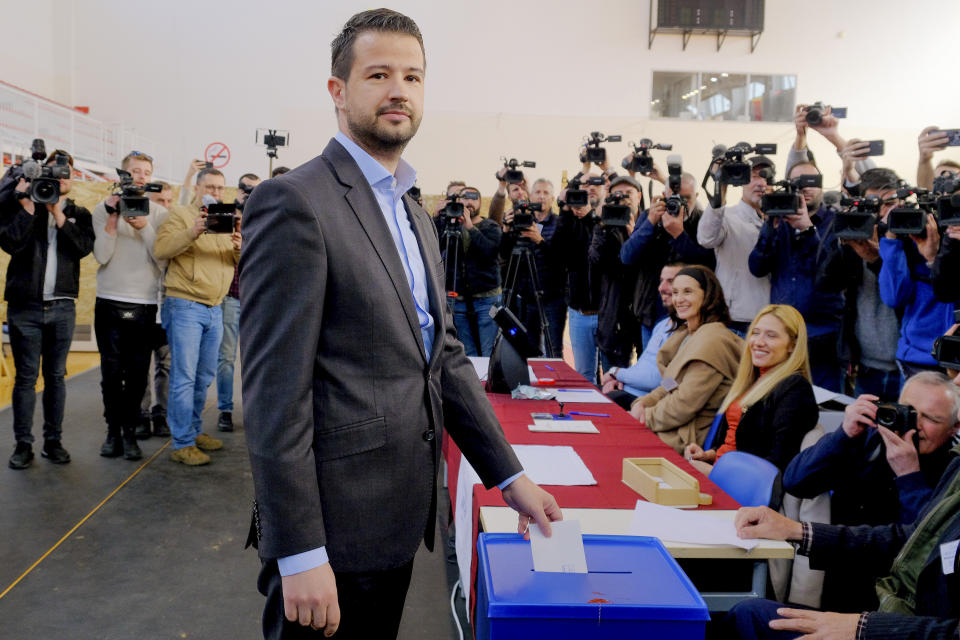 Jakov Milatovic, the candidate backed by governing parties advocating closer ties with Serbia, casts his ballot at a polling station in Montenegro's capital Podgorica, Sunday, April 2, 2023. Montenegrins are casting ballots on Sunday in a runoff presidential election that is a battle between a long-serving pro-Western incumbent and a newcomer promising changes in the small NATO member state in Europe that has been locked in political turmoil. (AP Photo/Risto Bozovic)