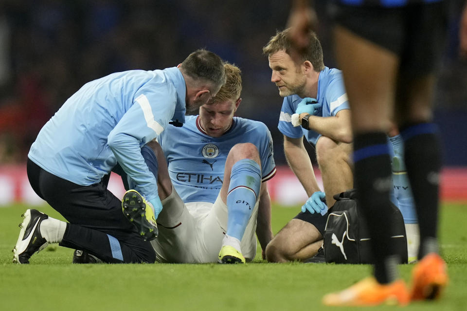Manchester City's Kevin De Bruyne is assisted after getting injured during the Champions League final soccer match between Manchester City and Inter Milan at the Ataturk Olympic Stadium in Istanbul, Turkey, Saturday, June 10, 2023. (AP Photo/Francisco Seco)