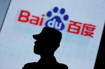 A security personnel stands guard at the opening session of Baidu's annual AI developers conference in Beijing