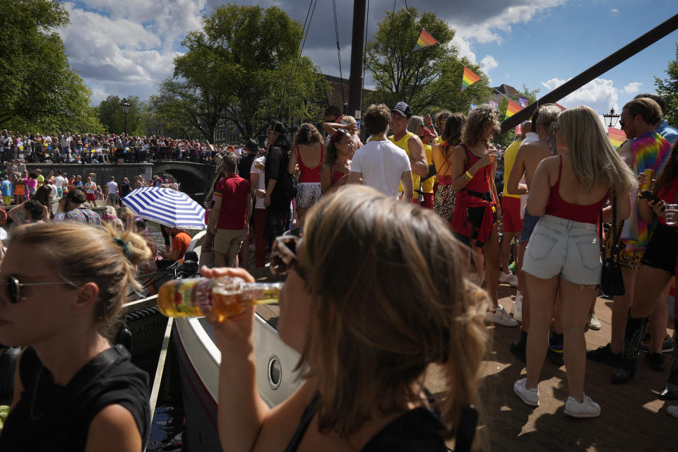 Hundreds of thousands of people lined canals in the Dutch capital to watch the colorful spectacle of the Pride Canal Parade return for the 25th edition after the last two events were canceled due to the COVID-19 pandemic, in Amsterdam, Netherlands, Saturday, Aug. 6, 2022. (AP Photo/Peter Dejong)