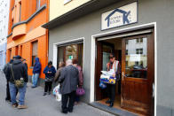 An old man in need leaves the soup kitchen "Kana" with food supplies from a food bank in a poor district of the city of Dortmund, western Germany, April 7, 2017. REUTERS/Wolfgang Rattay