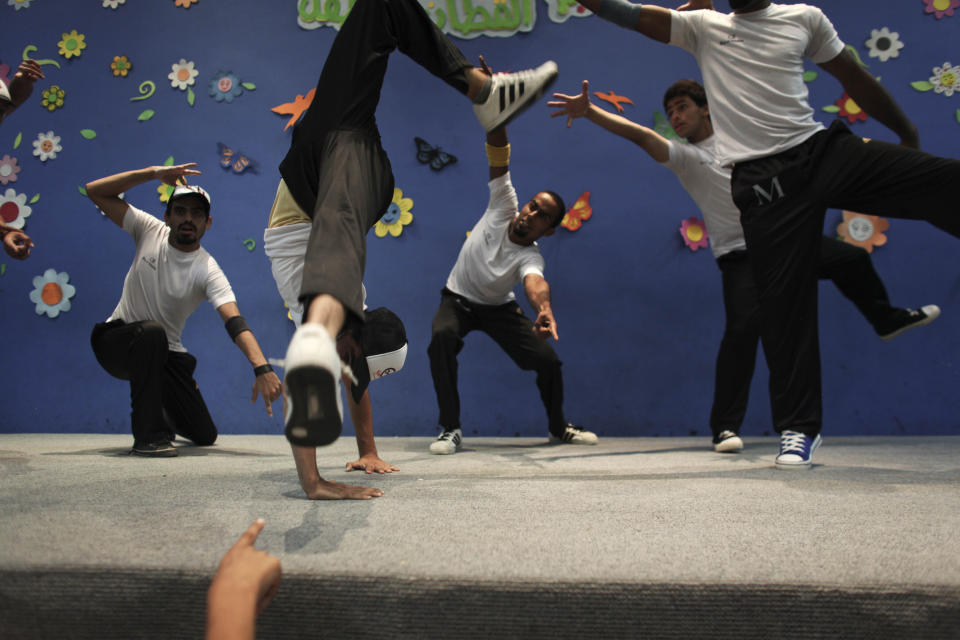 In this photo taken July 22, 2010, Palestinian members of the Camps Breakerz breakdancing troupe performance at a children's center in Gaza City. In the five decades since hip-hop emerged out of New York City, it has spread around the country and the world. And at each step there's been change and adaptation, as new, different voices came in and made it their own. Its foundations are steeped in the Black communities where it first made itself known but it's spread out until there’s no corner of the world that hasn’t been touched by it. (AP Photo/Tara Todras-Whitehill, file)
