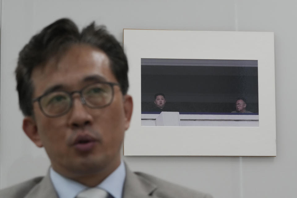 Ri Il Gyu, a former political counselor at the North Korean Embassy in Cuba who defected to South Korea last November, speaks near a photo showing North Korean leader Kim Jong Un, left, and his late father Kim Jong Il during an interview with The Associated Press at the Associated Press bureau in Seoul, South Korea, Friday, Aug. 2, 2024. (AP Photo/Ahn Young-joon)