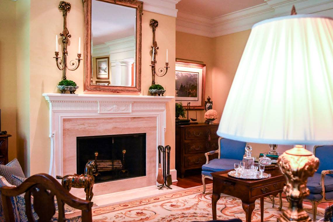 The grand room’s mantel is hand-carved and features views of the 16th fairway, pool, spa and garden from the veranda.