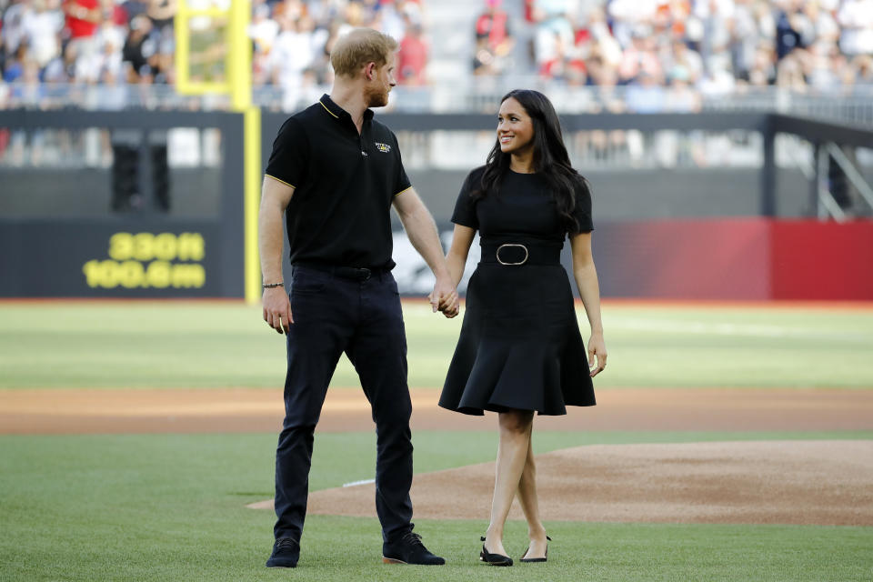 Prince Harry and the Duchess of Sussex arrive on the field prior to the start of the first of a two-game series between the New York Yankees and the Boston Red Sox at London Stadium.