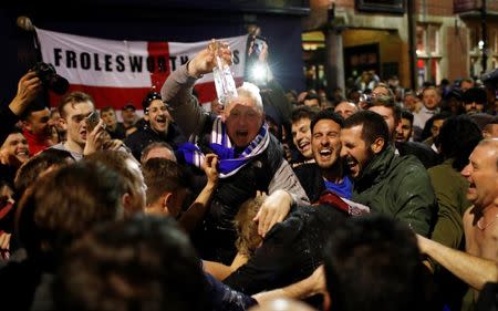 Britain Football Soccer - Leicester City fans watch the Chelsea v Tottenham Hotspur game in pub in Leicester - 2/5/16. Leicester City fans celebrate winning the Premier League. Reuters / Eddie Keogh