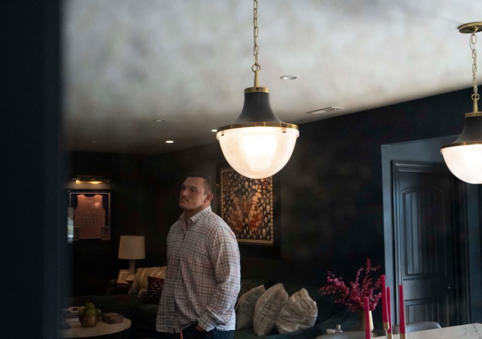 Ryan Kelly is reflected in a mirror in his living room Tuesday, Nov. 8, 2022, in Zionsville.