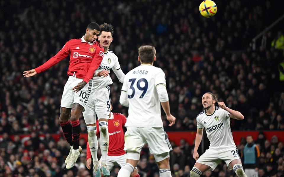 Manchester United's English striker Marcus Rashford (L) heads the ball and scores his team first goal during the English Premier League football match between Manchester United and Leeds United - Oli Scarff/Getty Images