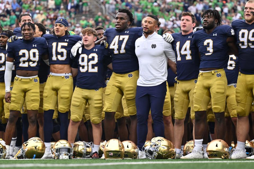 Sep 16, 2023; South Bend, Indiana, USA; Notre Dame Fighting Irish head coach Marcus Freeman stands with his team for the Notre Dame Alma Mater after Notre Dame defeated the Central Michigan Chippewas at Notre Dame Stadium. Mandatory Credit: Matt Cashore-USA TODAY Sports