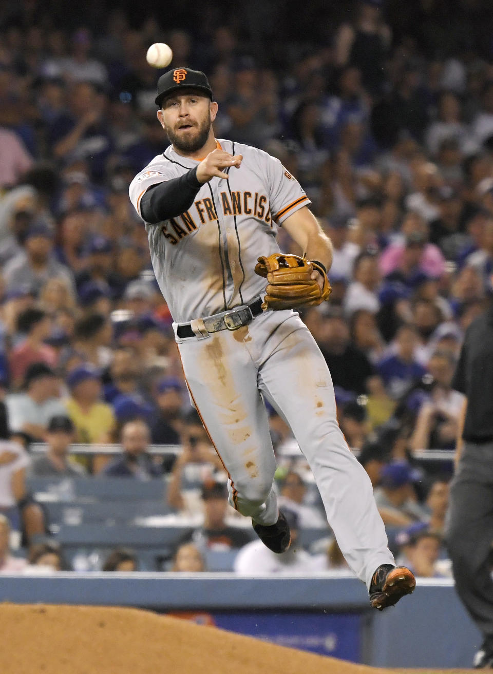 San Francisco Giants third baseman Evan Longoria throws out Los Angeles Dodgers' Brian Dozier at first during the fifth inning of a baseball game Monday, Aug. 13, 2018, in Los Angeles. (AP Photo/Mark J. Terrill)